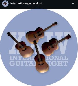 The logo for international guitar night. The logo is a soft blue grey with four guitars.